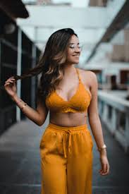 A 24 YEARS SLIM GIRL IN YELLOW DRESS TANDINGING POSITION WITH LONG HAIR